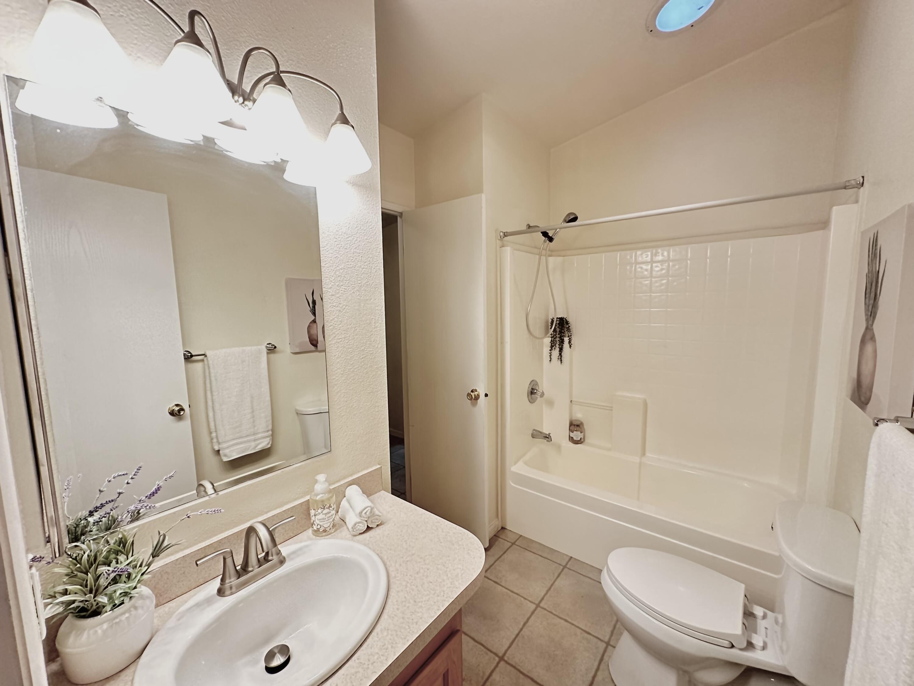 4713 Maple Trail, Unit LOS ROBLES ESTATES Redding, CA 96003 - Photo 12 of 22 a bathroom with a sink a toilet and shower