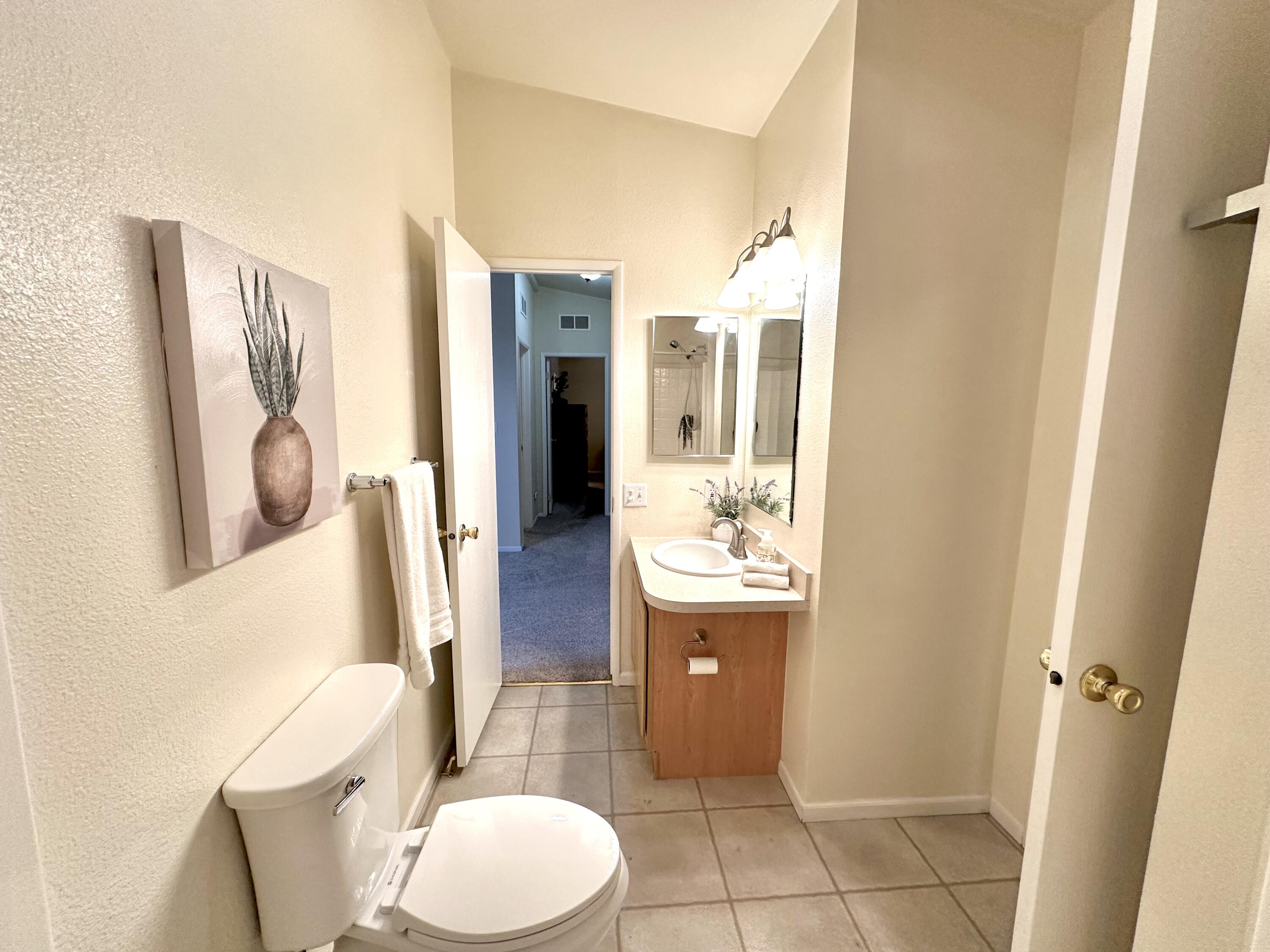 4713 Maple Trail, Unit LOS ROBLES ESTATES Redding, CA 96003 - Photo 13 of 22 a bathroom with a toilet sink and mirror