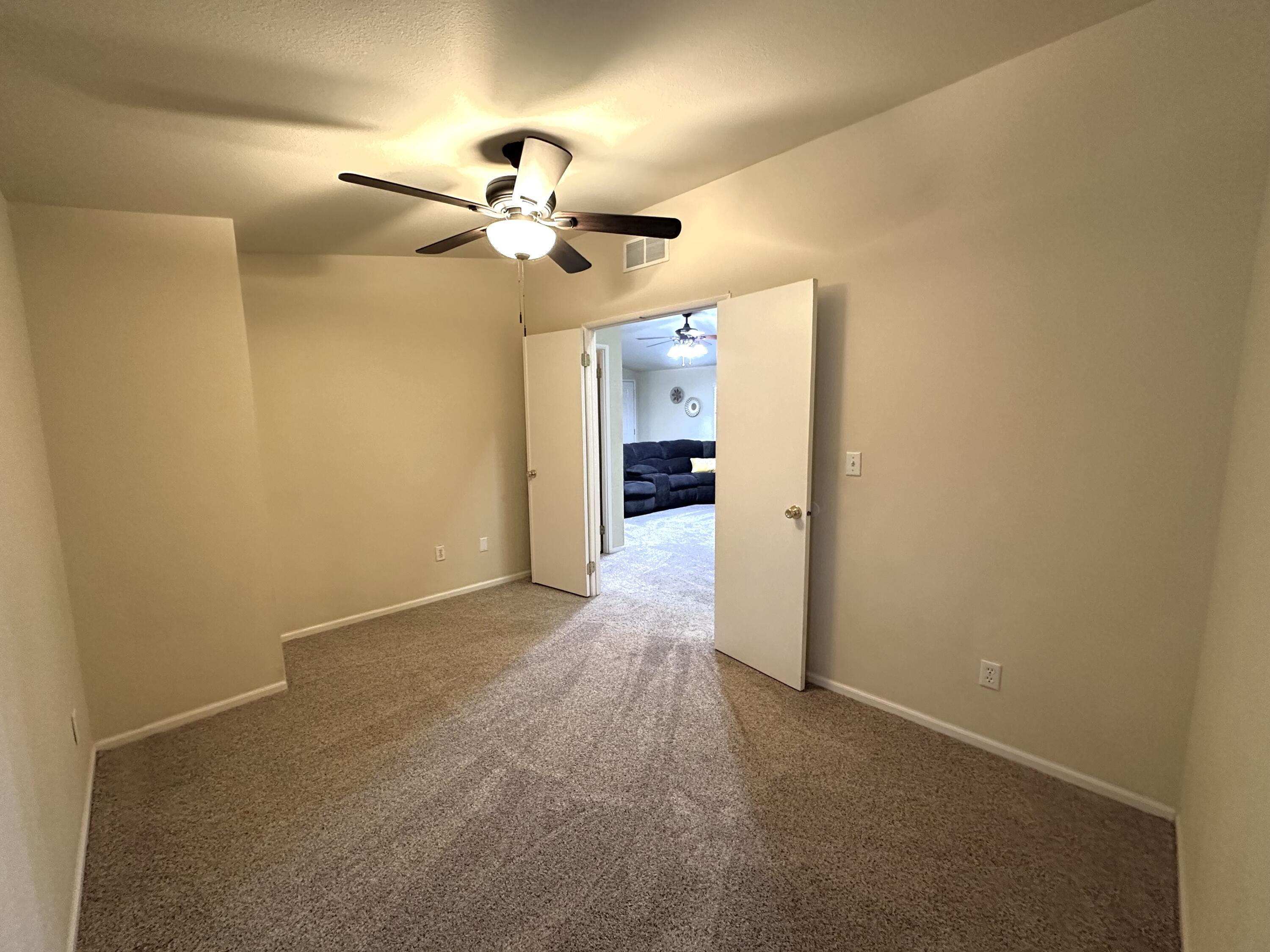 4713 Maple Trail, Unit LOS ROBLES ESTATES Redding, CA 96003 - Photo 15 of 22 a view of empty room with a ceiling fan and a window
