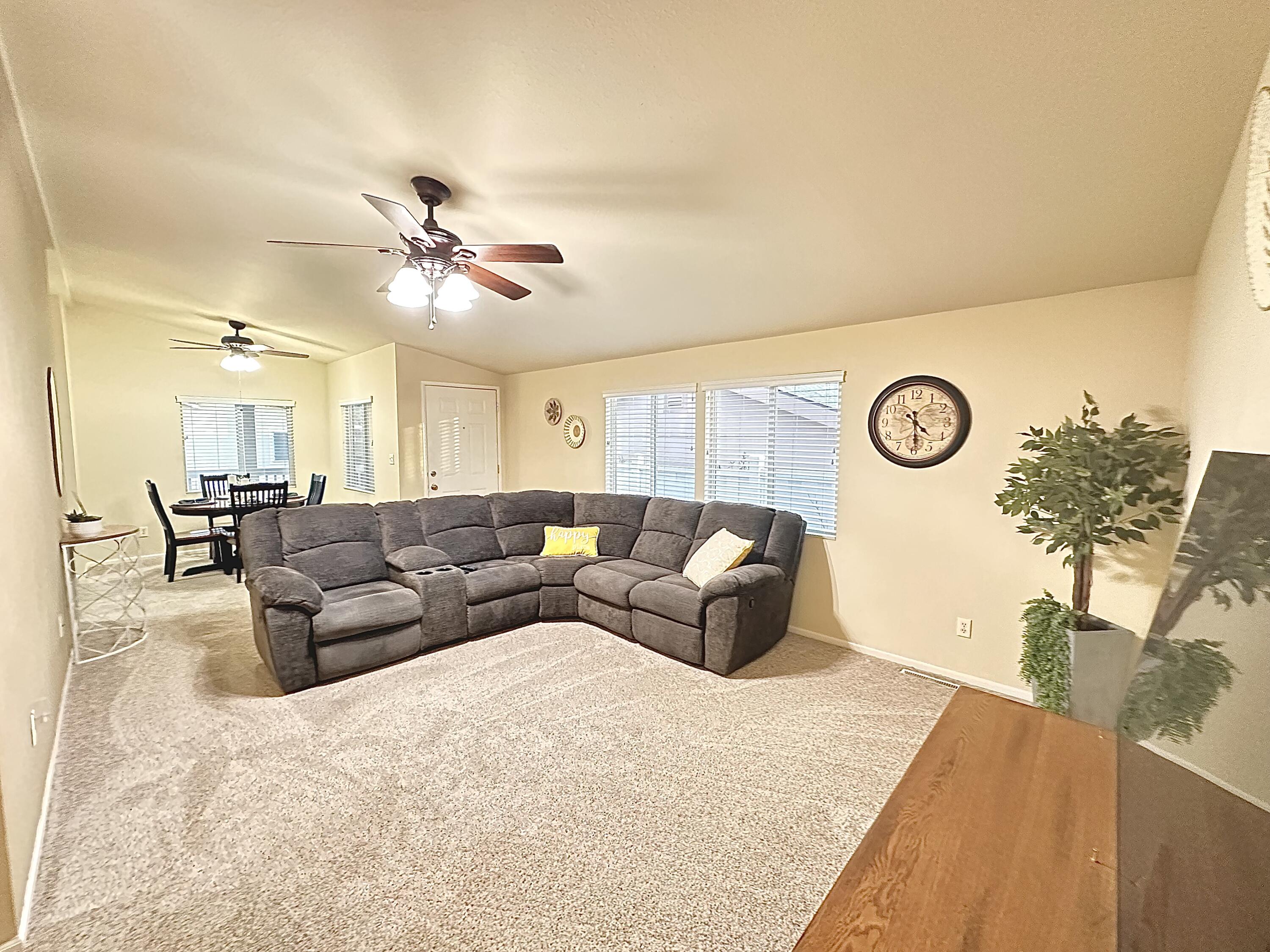 4713 Maple Trail, Unit LOS ROBLES ESTATES Redding, CA 96003 - Photo 3 of 22 a living room with furniture and a large window