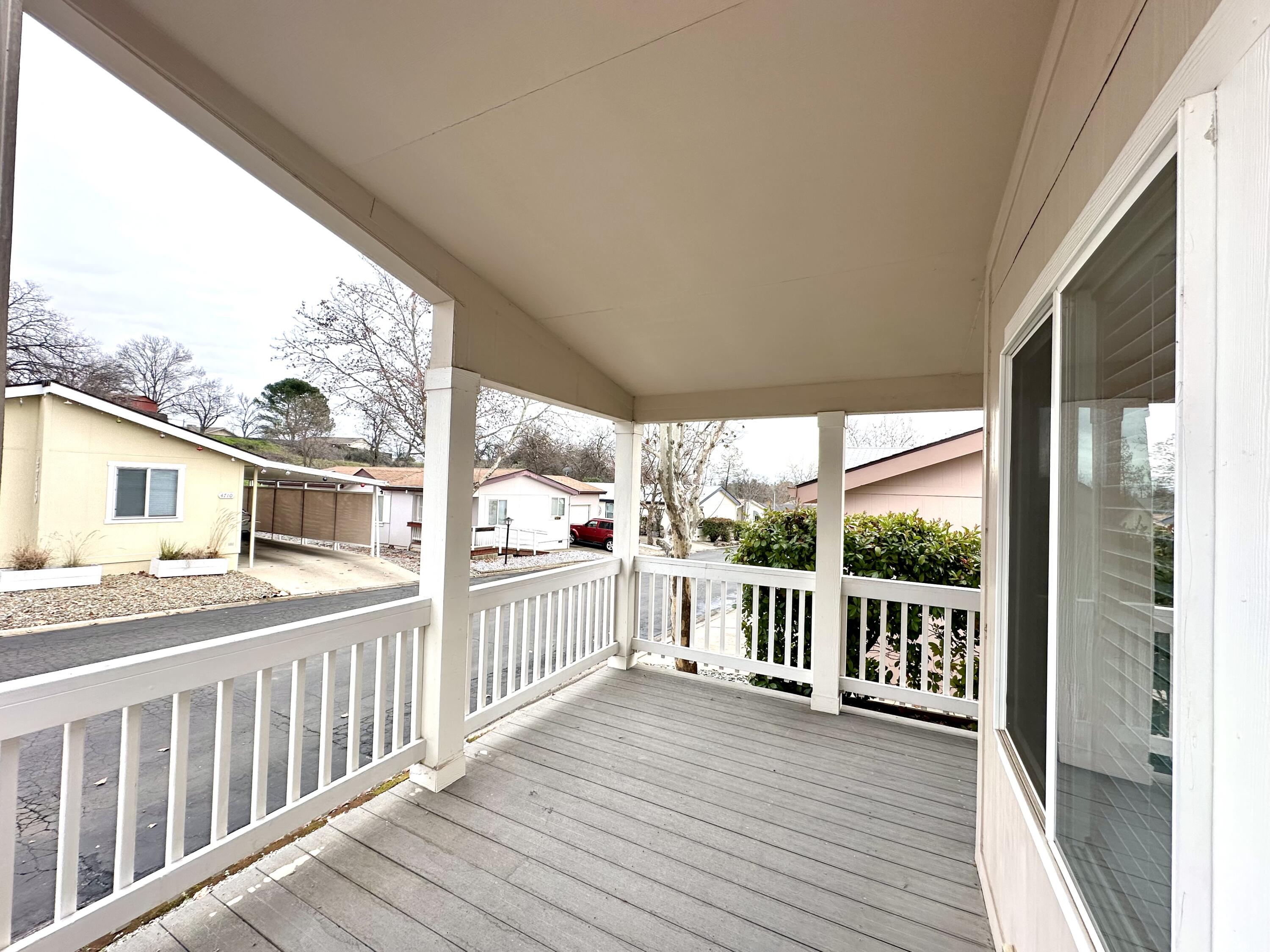4713 Maple Trail, Unit LOS ROBLES ESTATES Redding, CA 96003 - Photo 4 of 22 a view of a house with wooden deck