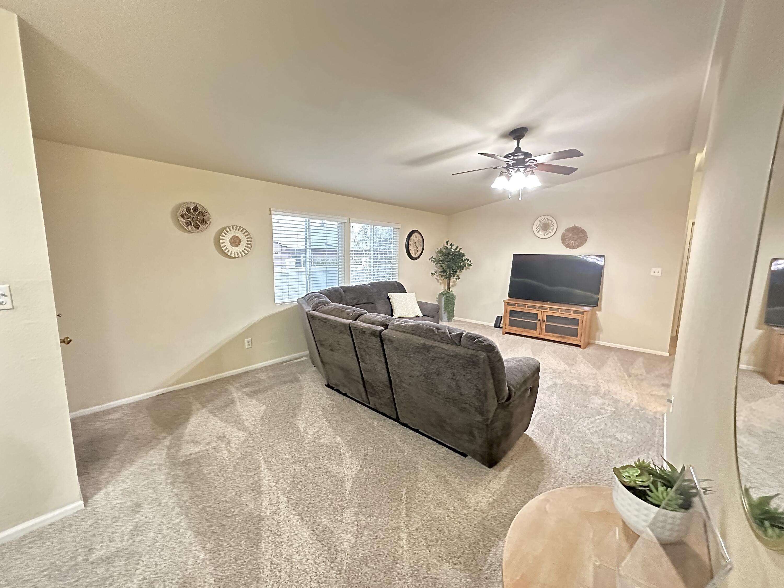 4713 Maple Trail, Unit LOS ROBLES ESTATES Redding, CA 96003 - Photo 6 of 22 a living room with furniture and a flat screen tv