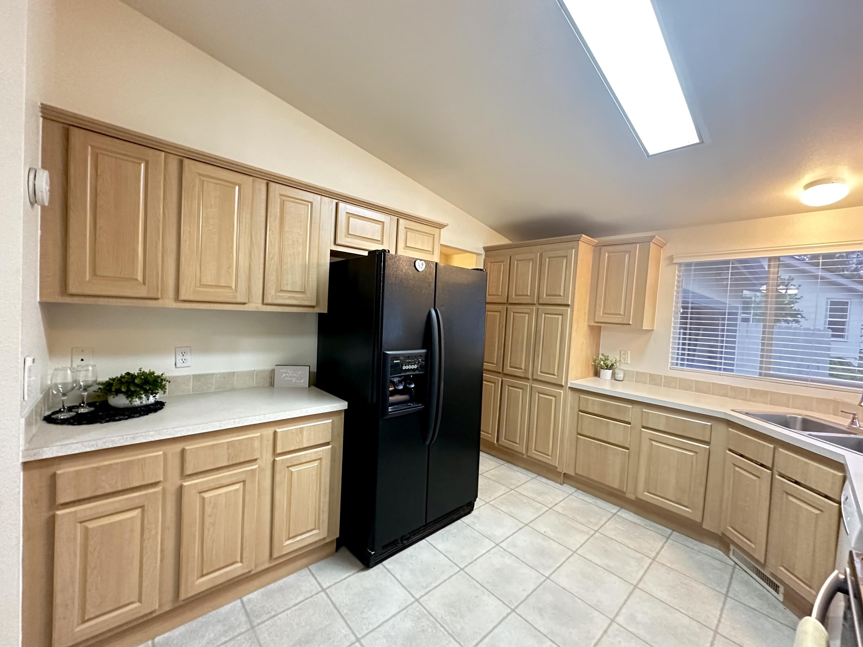4713 Maple Trail, Unit LOS ROBLES ESTATES Redding, CA 96003 - Photo 8 of 22 a kitchen with stainless steel appliances a refrigerator sink and cabinets