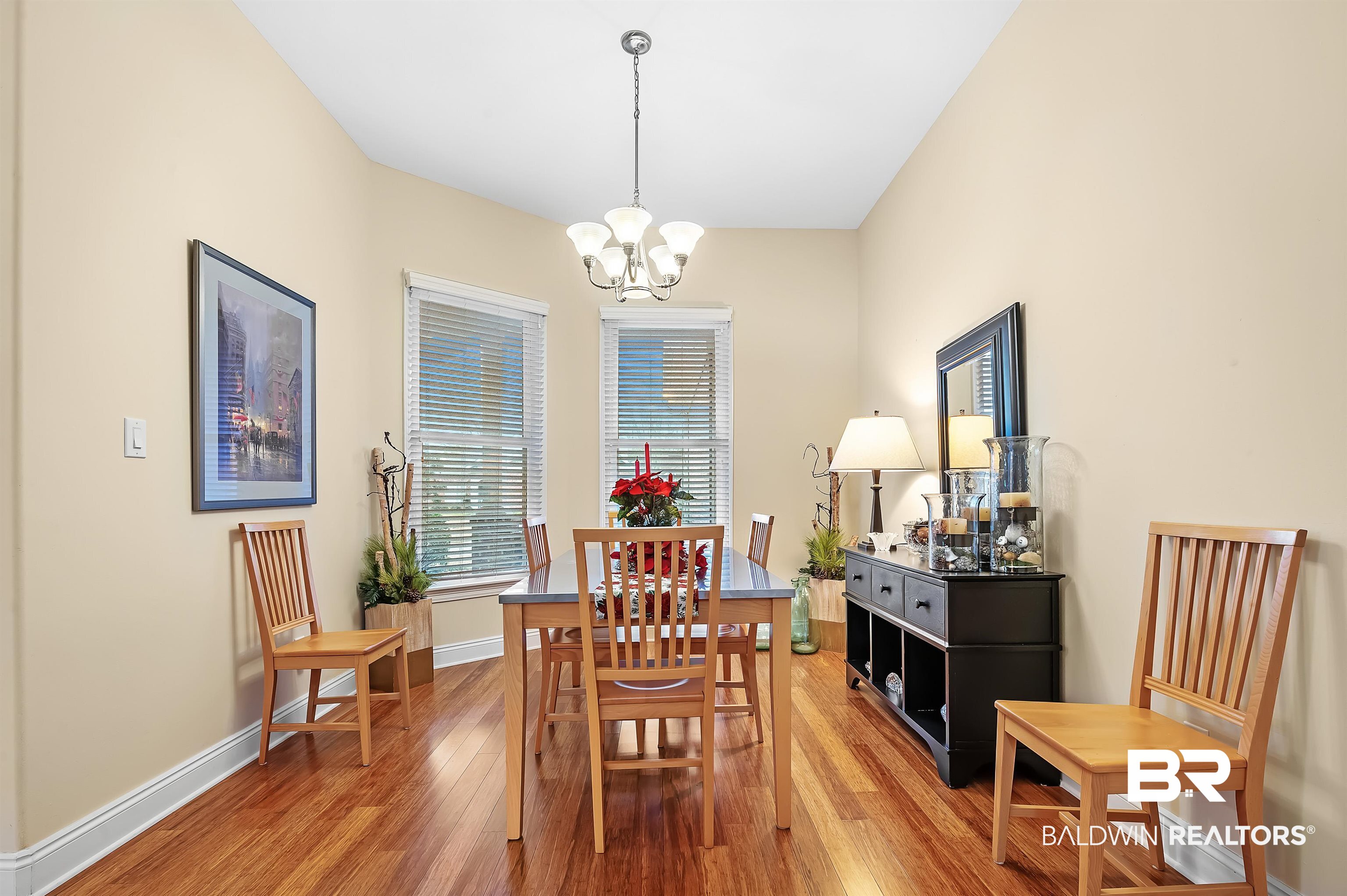 22726 Inverness Way Foley, AL 36535 - Photo 21 of 51 Dining area featuring hardwood / wood-style flooring and an inviting chandelier