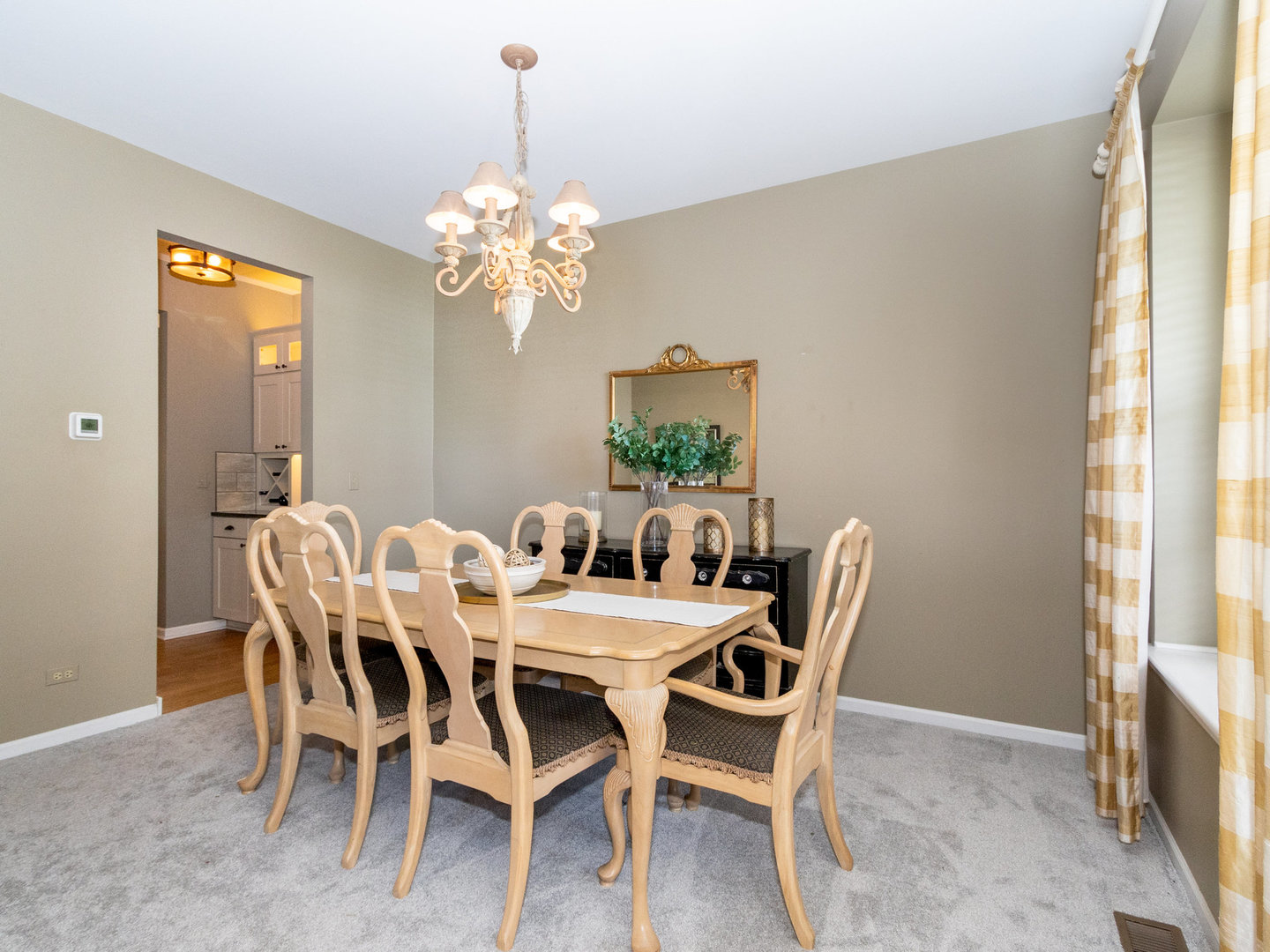 1195 Amaranth Drive Naperville, IL 60564 - Photo 14 of 48 a view of a dining room with furniture a chandelier and a window