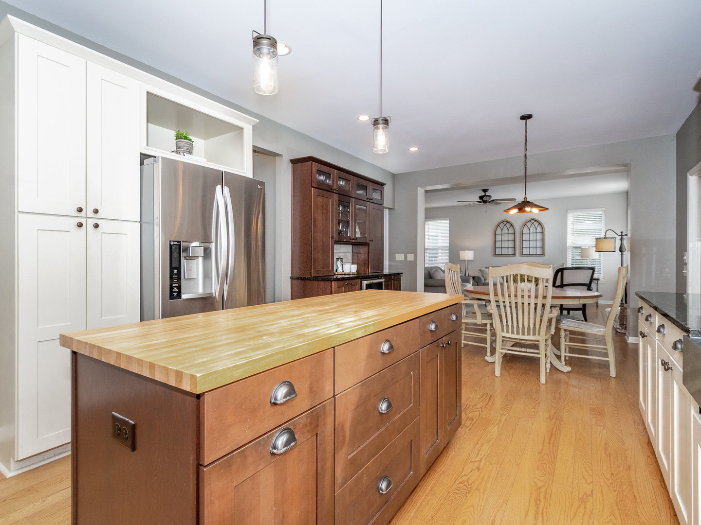 1195 Amaranth Drive Naperville, IL 60564 - Photo 7 of 48 a kitchen with a refrigerator a sink and chairs