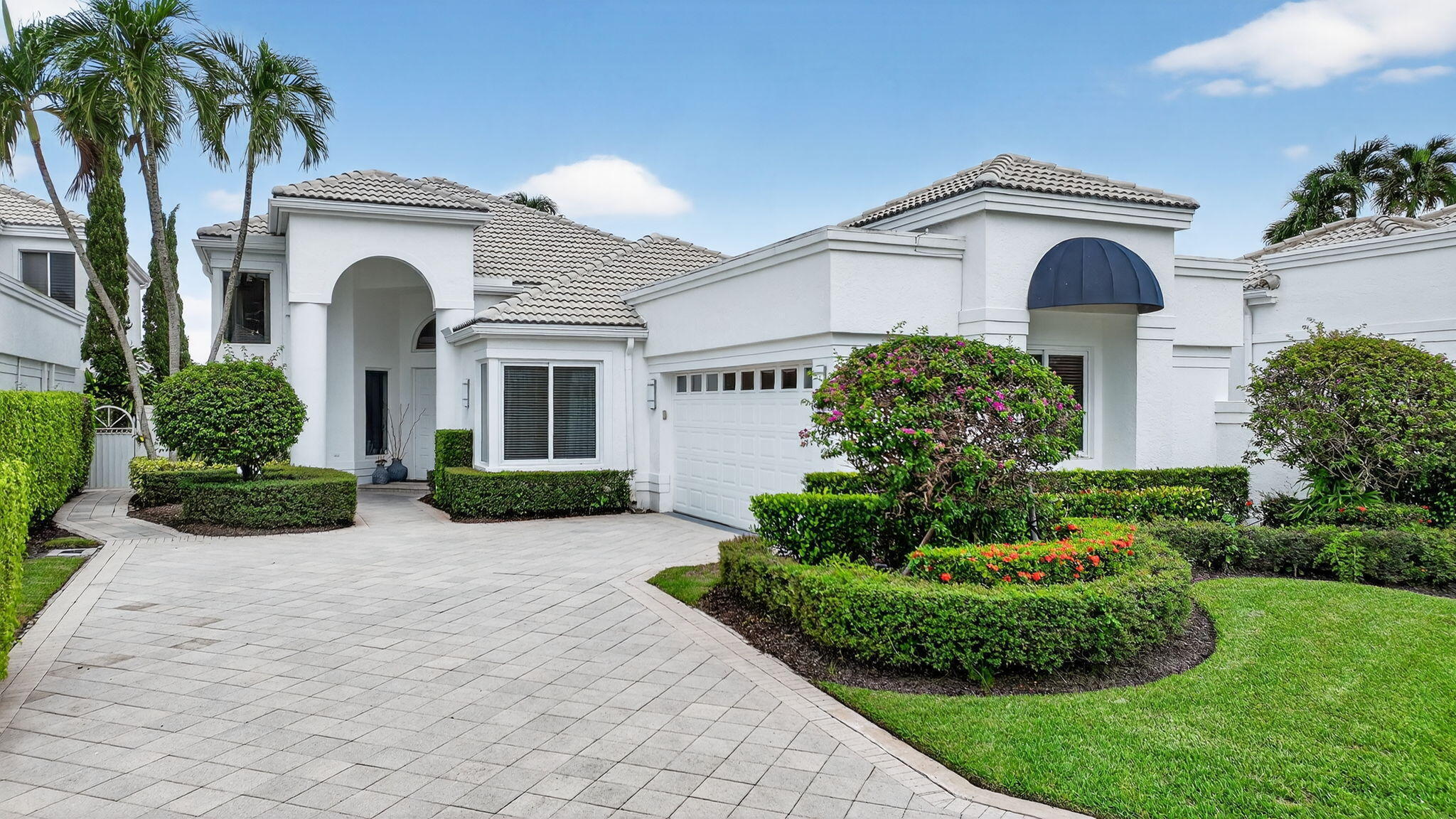 2563 Northwest 63rd Street Boca Raton, FL 33496 - Photo 2 of 65 a front view of a house with a yard