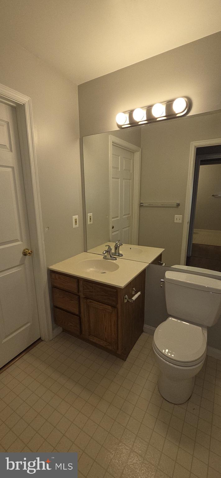 11192 Rienzi Place, Unit 102 Manassas, VA 20109 - Photo 13 of 19 a bathroom with a toilet a sink and mirror