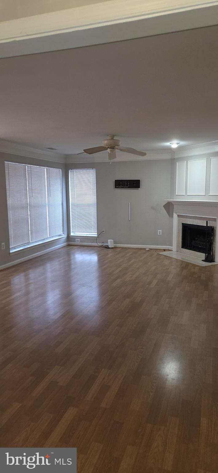 11192 Rienzi Place, Unit 102 Manassas, VA 20109 - Photo 2 of 19 a view of an empty room with wooden floor and a window