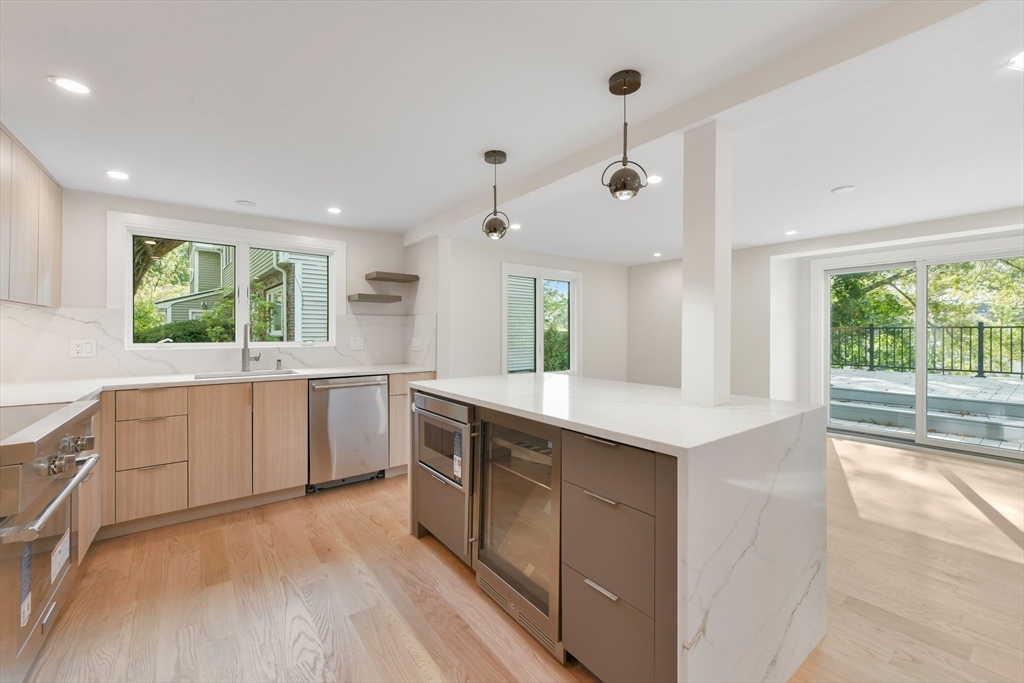 72 Wallis Road Brookline, MA 02467 - Photo 13 of 42 a kitchen with a stove a sink and a refrigerator