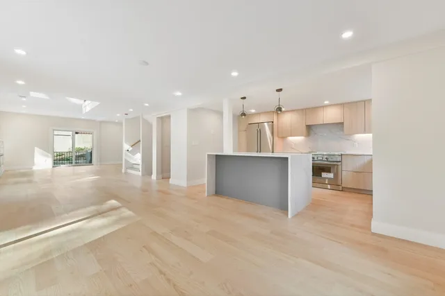 a view of kitchen with kitchen island wooden cabinets and center island