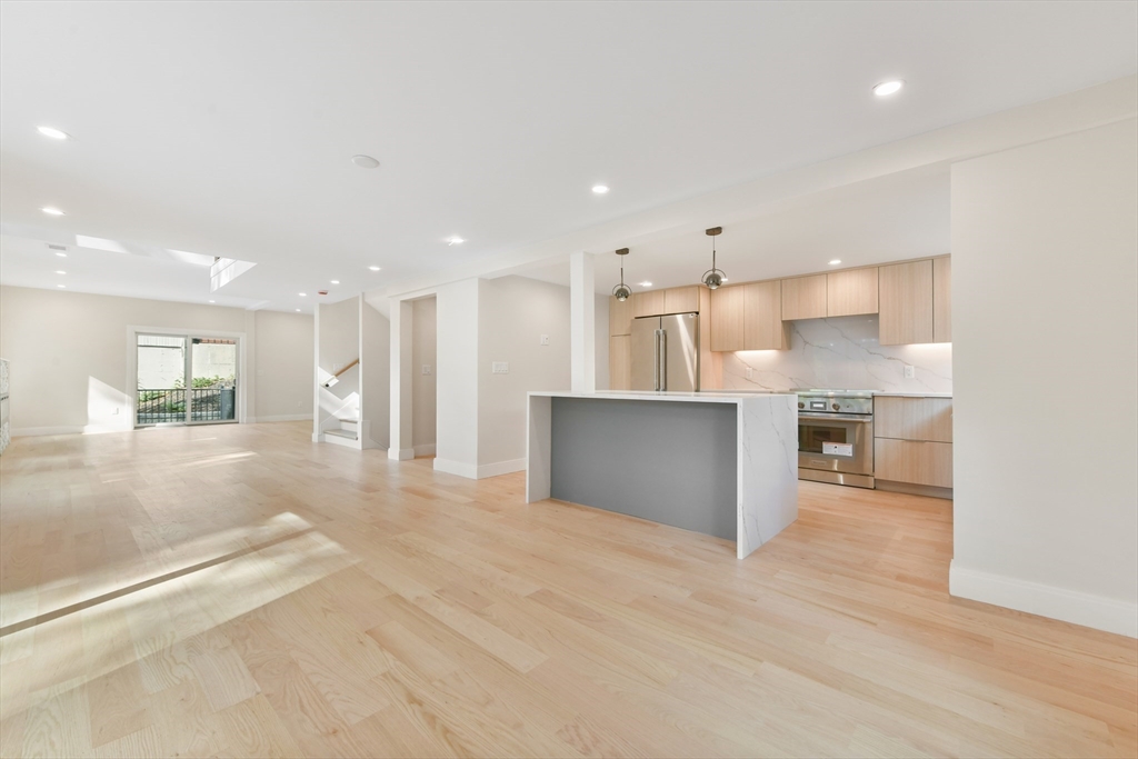 72 Wallis Road Brookline, MA 02467 - Photo 15 of 42 a view of kitchen with kitchen island wooden cabinets and center island