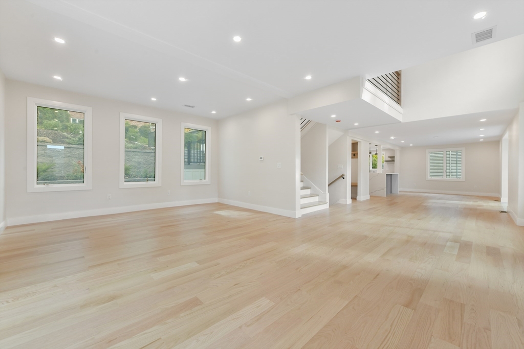 72 Wallis Road Brookline, MA 02467 - Photo 18 of 42 an empty room with wooden floor and windows