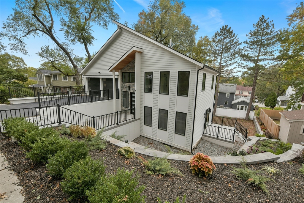 72 Wallis Road Brookline, MA 02467 - Photo 2 of 42 a view of a white house with a yard and fence
