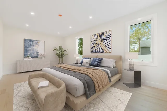 a spacious bedroom with a large bed and a painting on the wall