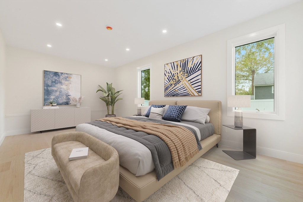 72 Wallis Road Brookline, MA 02467 - Photo 27 of 42 a spacious bedroom with a large bed and a painting on the wall