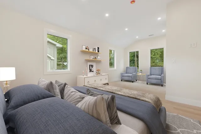 a large bedroom with two beds and a large window