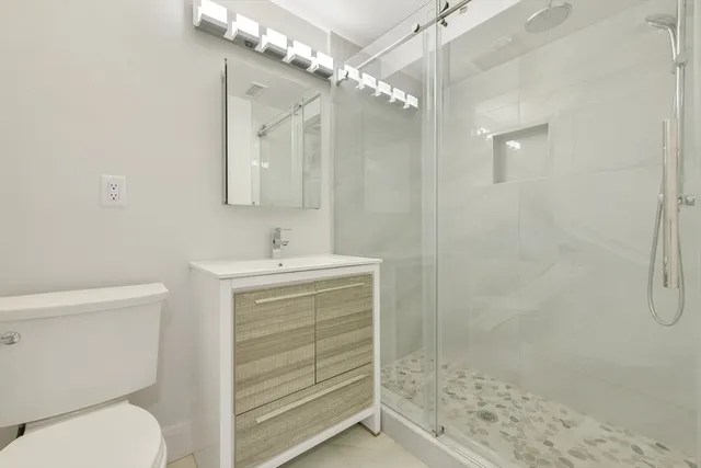 a bathroom with a sink toilet and shower