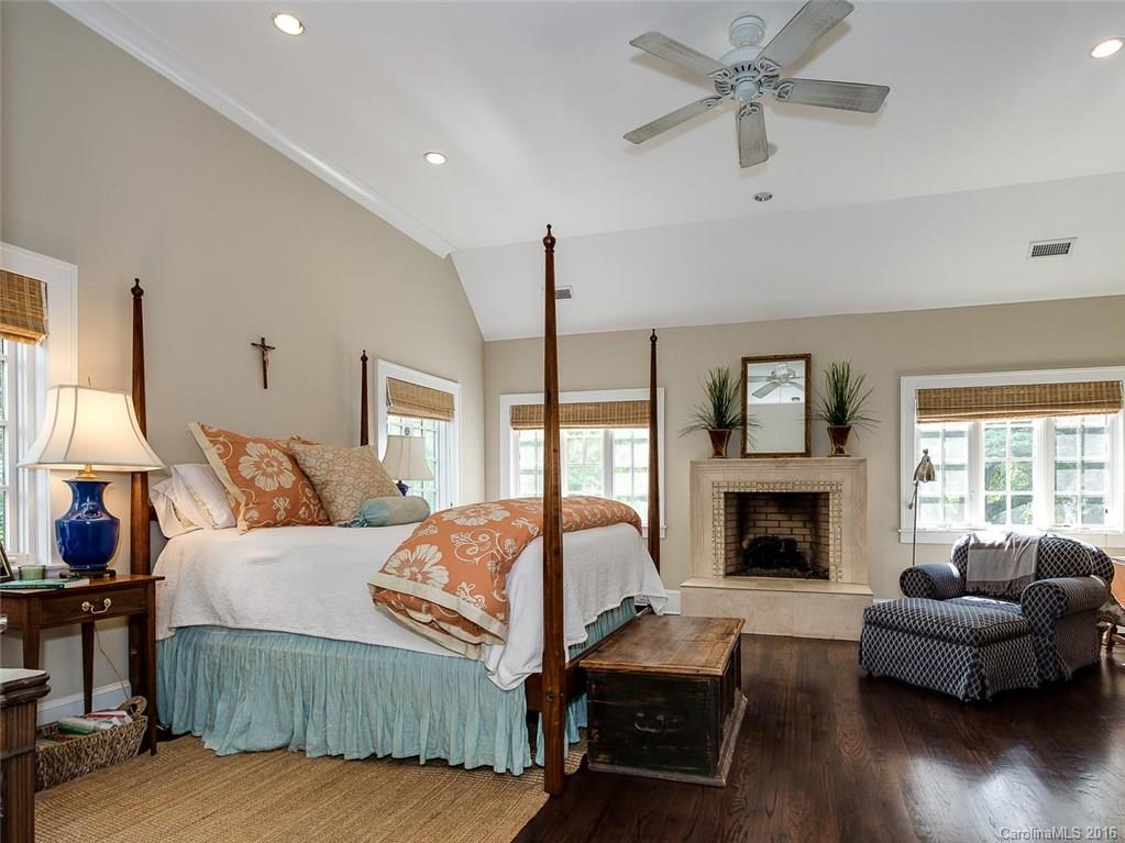 728 Berkeley Avenue Charlotte, NC 28203 - Photo 12 of 24 a bedroom with a bed and a fireplace