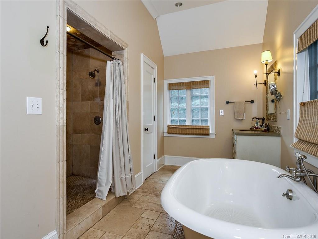 728 Berkeley Avenue Charlotte, NC 28203 - Photo 14 of 24 a bathroom with a tub a sink and a large mirror