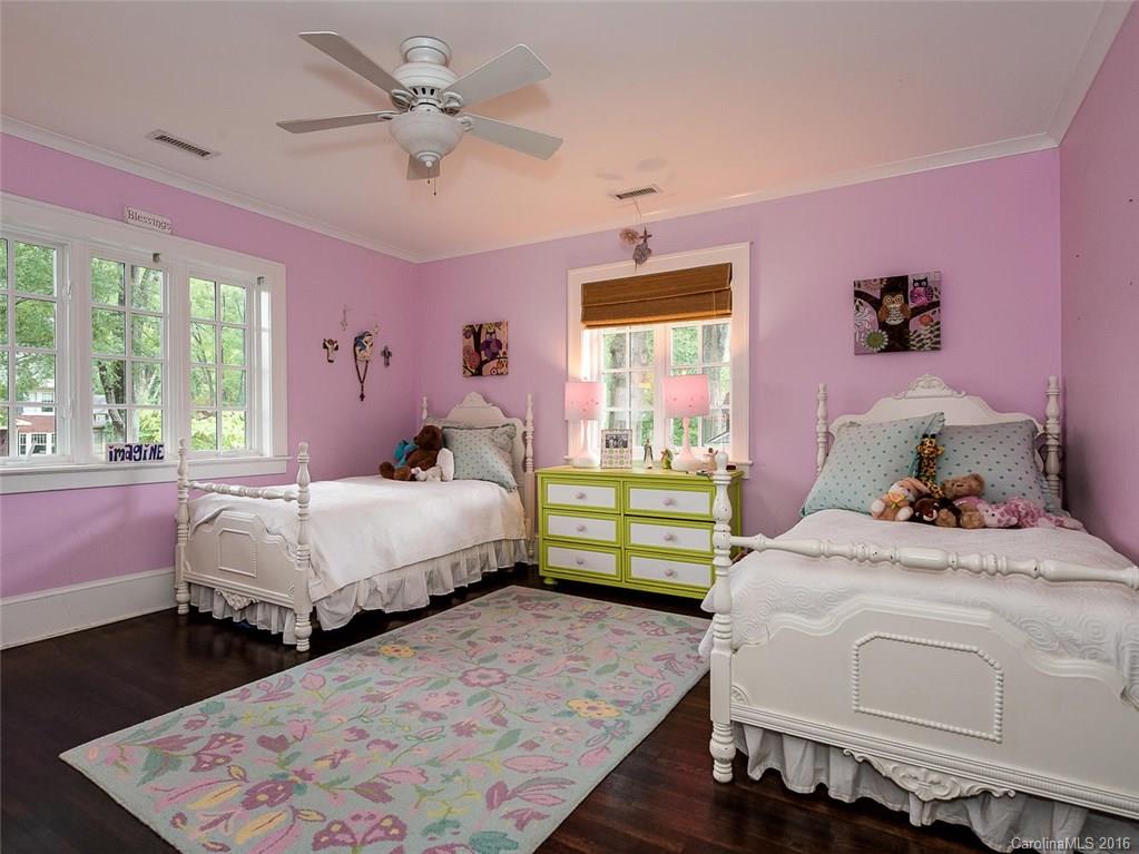 728 Berkeley Avenue Charlotte, NC 28203 - Photo 16 of 24 a bedroom with a bed a chandelier and a window