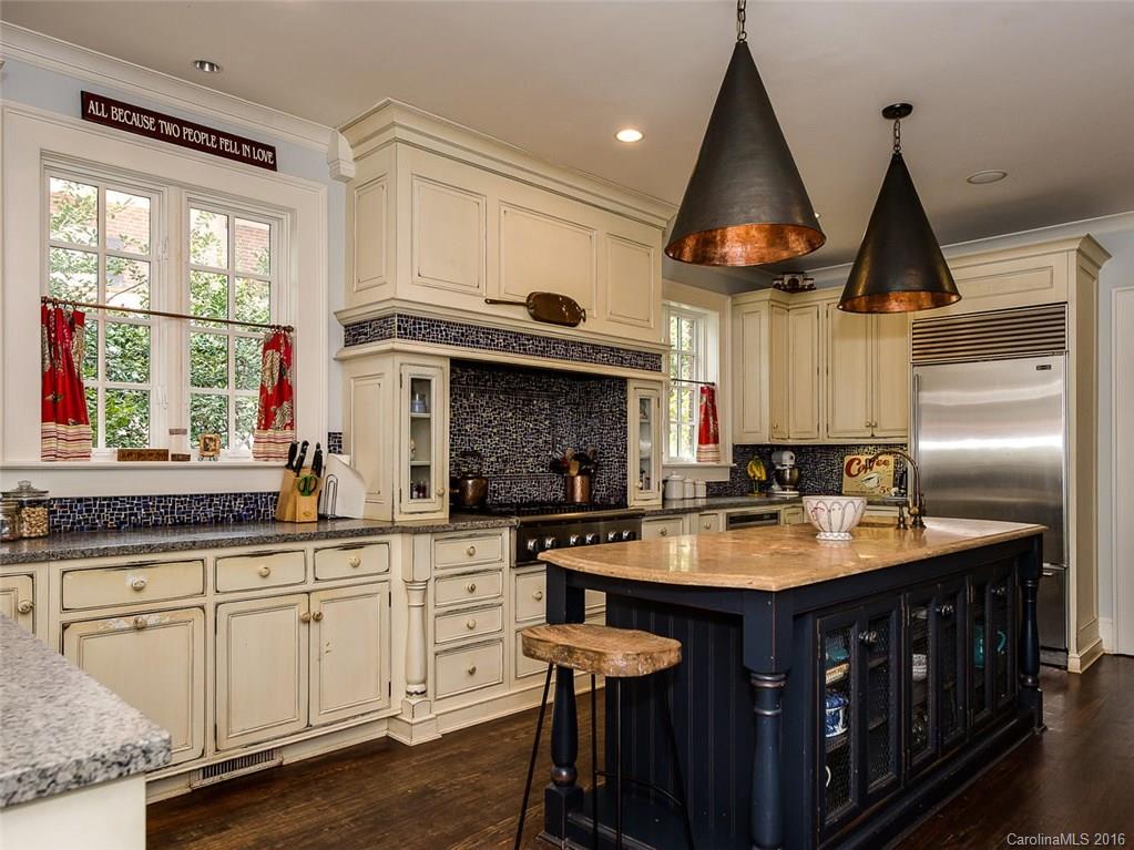 728 Berkeley Avenue Charlotte, NC 28203 - Photo 7 of 24 a kitchen with stainless steel appliances granite countertop a sink a stove and a wooden cabinets