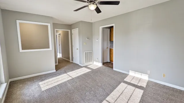 a view of room with window and ceiling fan