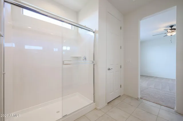 a bathroom with a glass shower door