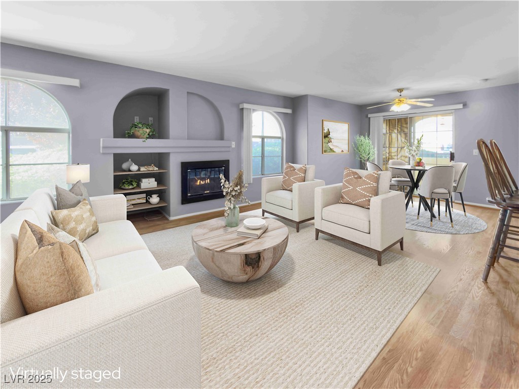 7950 West Flamingo Road, Unit 1169 Las Vegas, NV 89147 - Photo 38 of 42 Living room with fireplace & open floor plan. Virtually staged