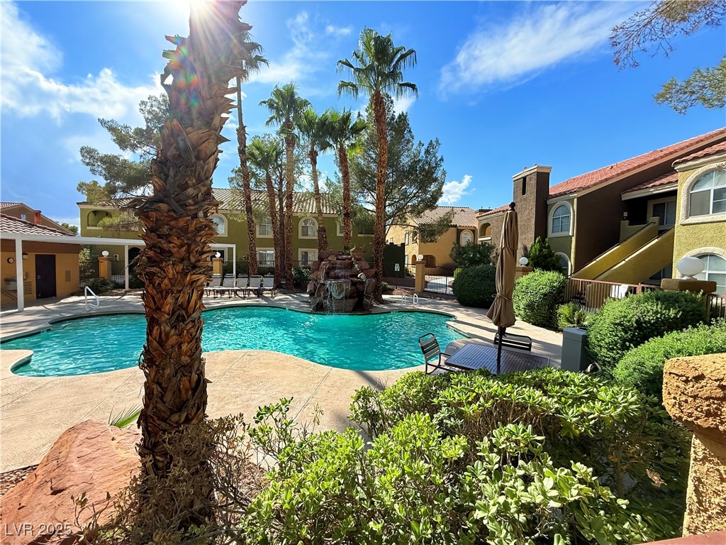 7950 West Flamingo Road, Unit 1169 Las Vegas, NV 89147 - Photo 21 of 42 Sparkling pool with waterfall just steps from home