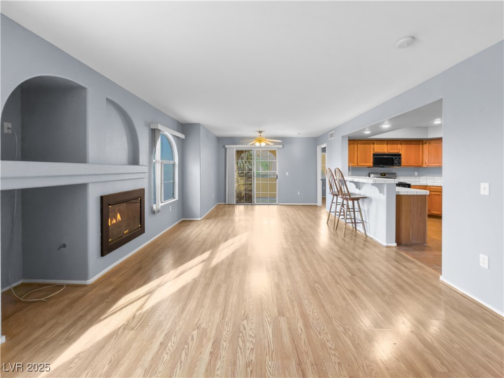 7950 West Flamingo Road, Unit 1169 Las Vegas, NV 89147 - Photo 39 of 42 Living room with fireplace & open floor plan