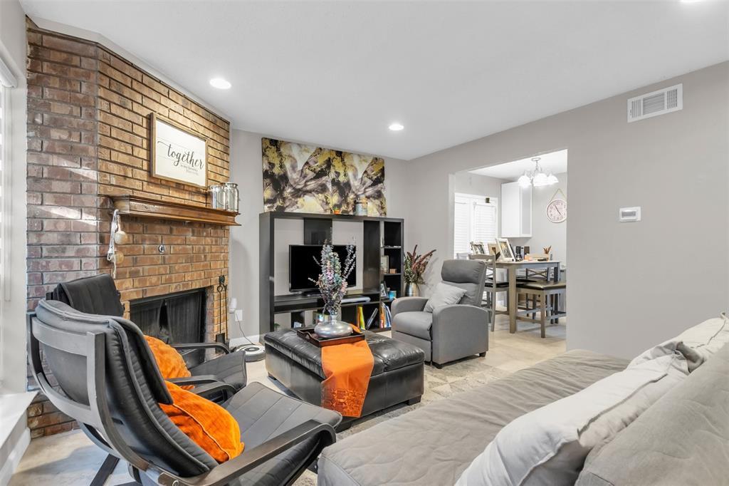 7670 Kings Ridge Road Frisco, TX 75035 - Photo 12 of 24 Living room with recessed lighting, carpet flooring, a fireplace, and a chandelier