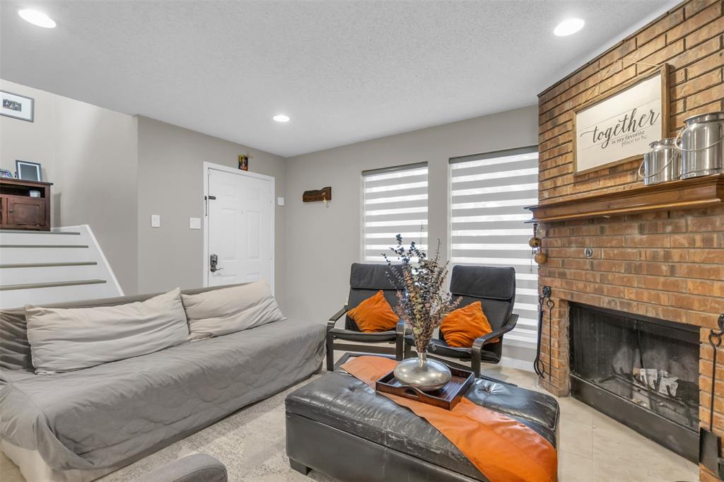 7670 Kings Ridge Road Frisco, TX 75035 - Photo 13 of 24 Living room featuring recessed lighting, tile patterned flooring, a fireplace, and stairs