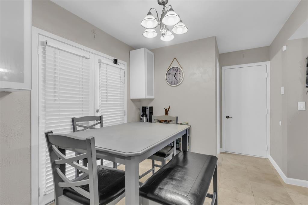 7670 Kings Ridge Road Frisco, TX 75035 - Photo 14 of 24 Dining space with a chandelier and light tile patterned floors