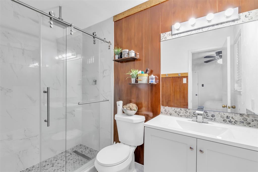 7670 Kings Ridge Road Frisco, TX 75035 - Photo 17 of 24 Bathroom featuring vanity, a marble finish shower, and ceiling fan