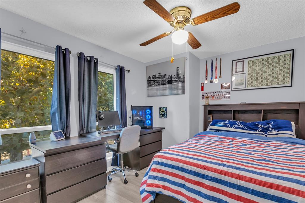 7670 Kings Ridge Road Frisco, TX 75035 - Photo 21 of 24 Bedroom featuring light wood-style floors, a textured ceiling, an office area, and a ceiling fan