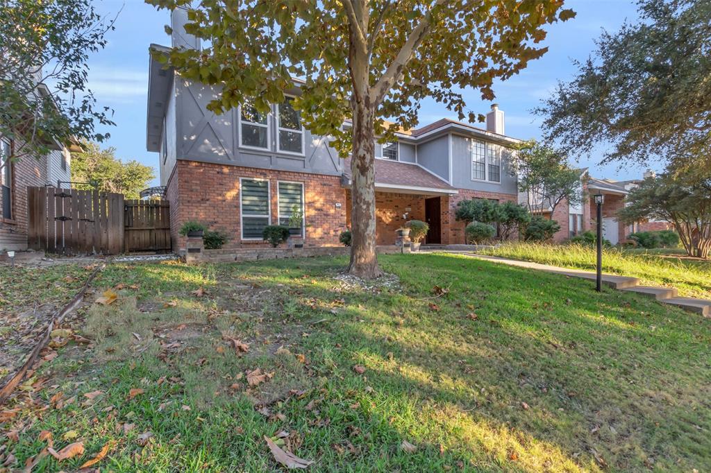 7670 Kings Ridge Road Frisco, TX 75035 - Photo 3 of 24 Traditional home with brick siding, a chimney, and a gate