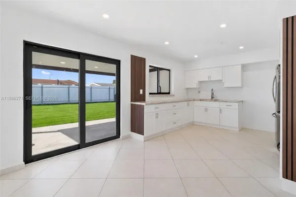 a view of a kitchen with a sink and dishwasher cabinets