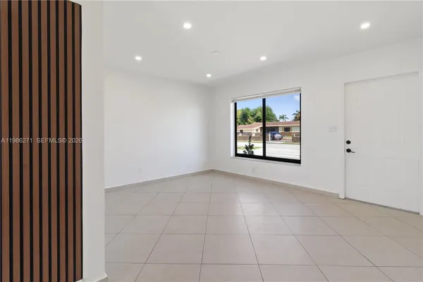 a view of hallway with window and furniture