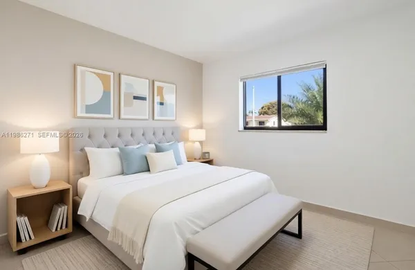 a bedroom with a bed and a painting on the wall