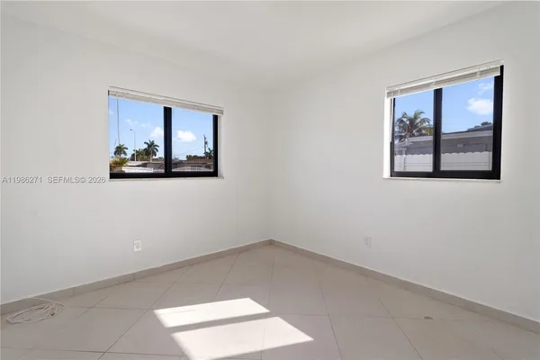 a view of a hallway with paintings on the wall