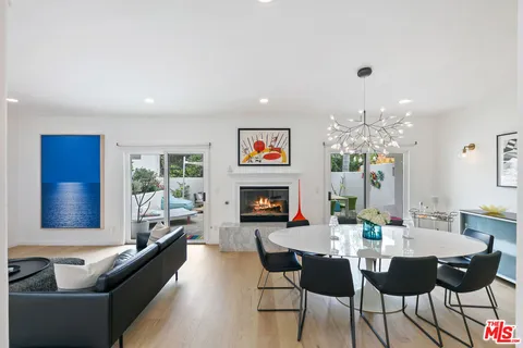 a living room with fireplace furniture and a chandelier