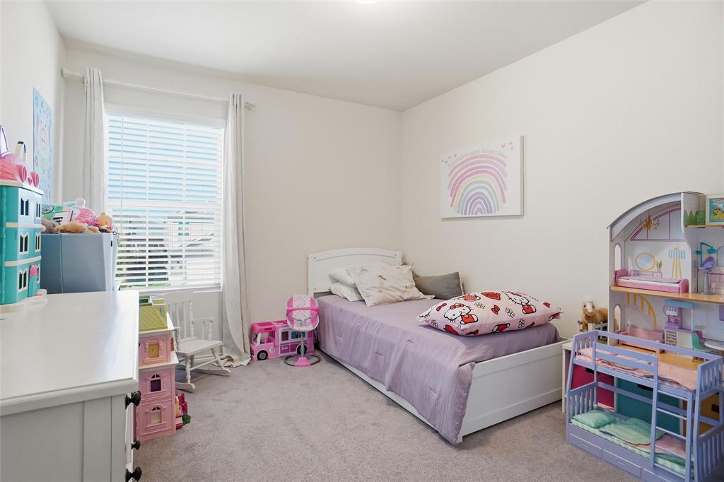 1719 Ackerly Drive Forney, TX 75126 - Photo 17 of 27 a bedroom with a bed and a window