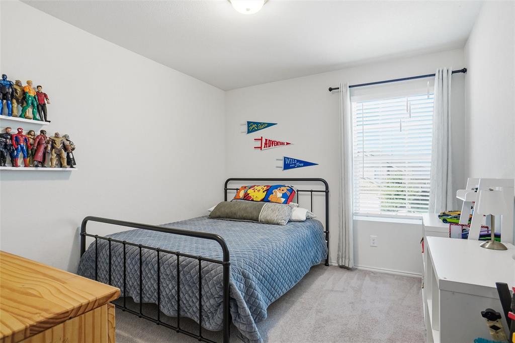 1719 Ackerly Drive Forney, TX 75126 - Photo 18 of 27 a bedroom with a bed and a window