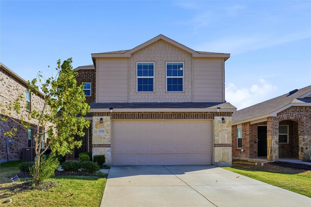 1719 Ackerly Drive Forney, TX 75126 - Photo 2 of 27 a front view of a house with a garden