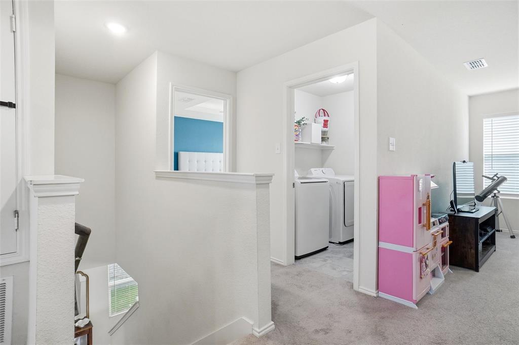 1719 Ackerly Drive Forney, TX 75126 - Photo 22 of 27 a bedroom with a bed and a window