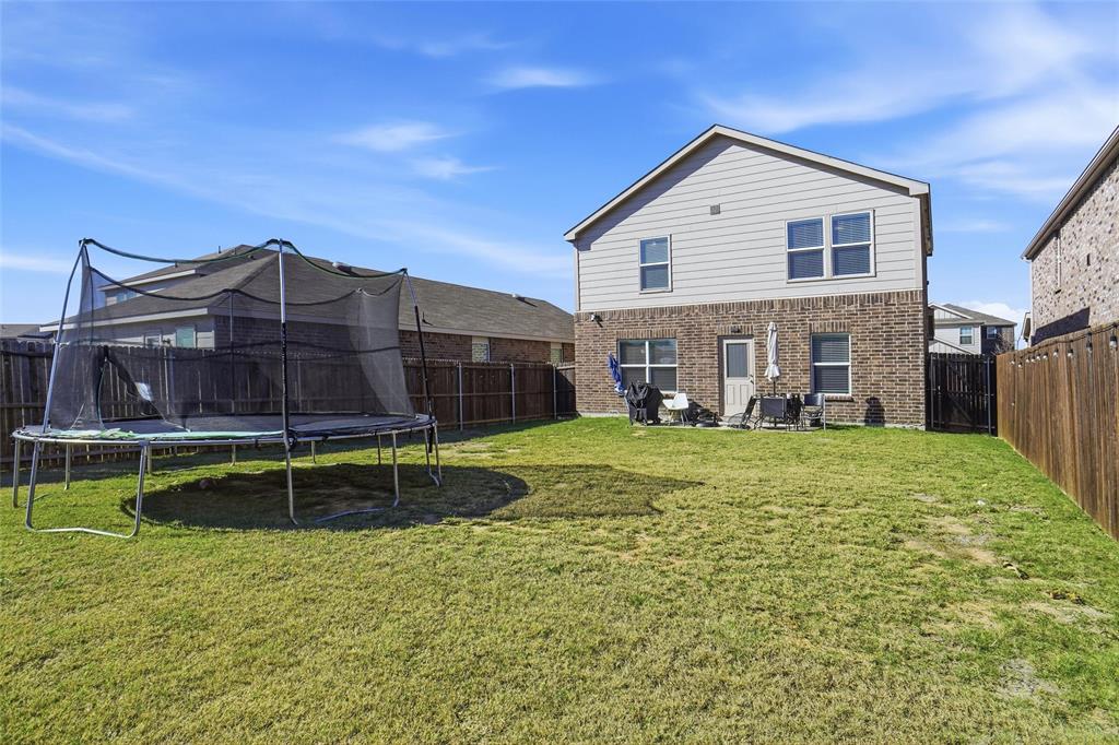 1719 Ackerly Drive Forney, TX 75126 - Photo 23 of 27 a view of a house with a yard and sitting area
