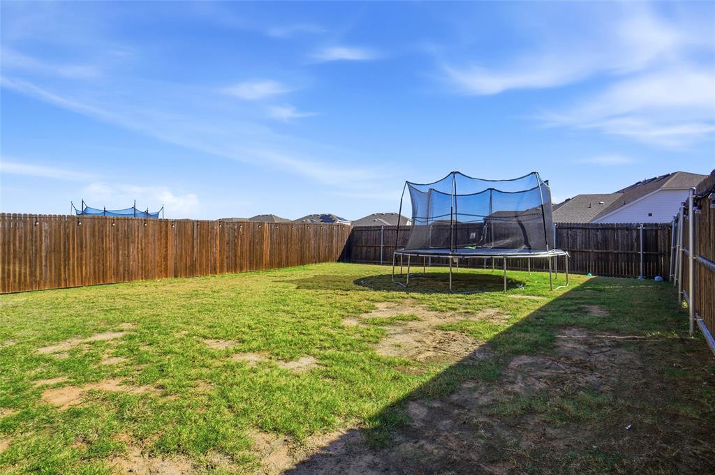 1719 Ackerly Drive Forney, TX 75126 - Photo 25 of 27 a view of a house with a yard