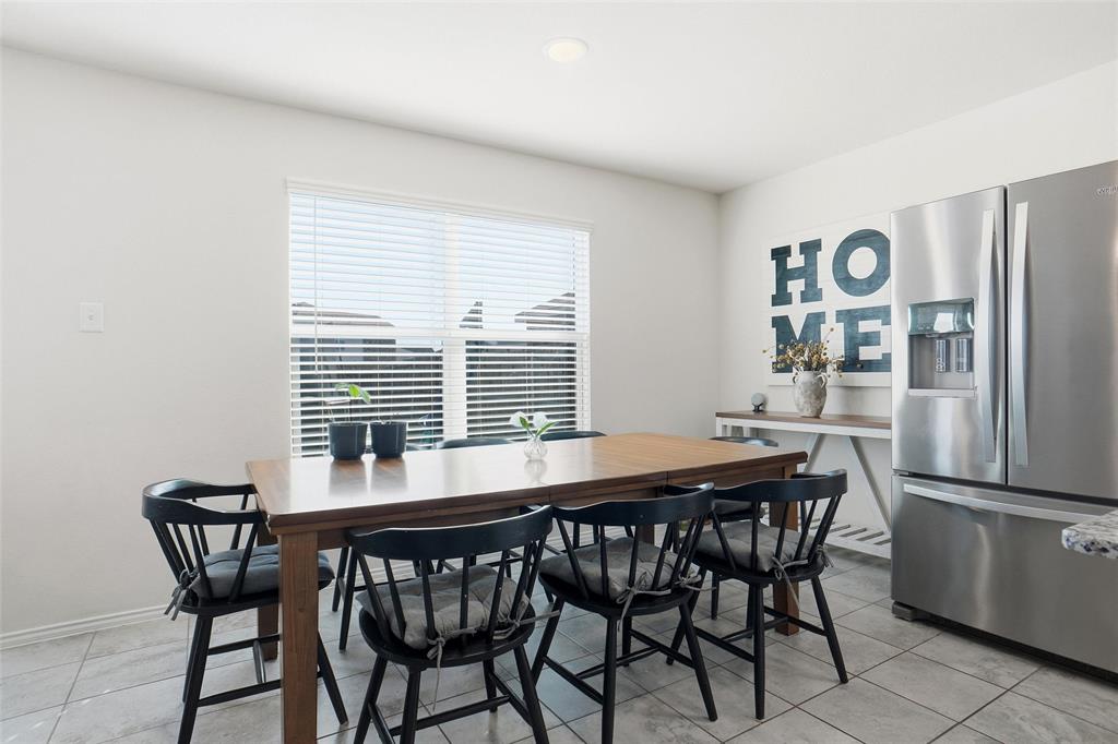 1719 Ackerly Drive Forney, TX 75126 - Photo 7 of 27 a dining room with furniture and window