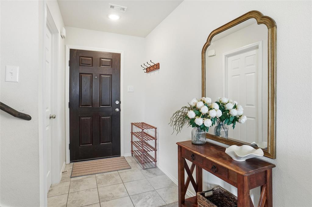 1719 Ackerly Drive Forney, TX 75126 - Photo 9 of 27 a dining room with furniture and potted plant